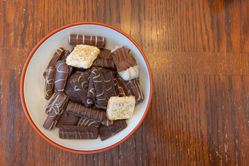 Collection of chocolate cookies and candies in a bowl