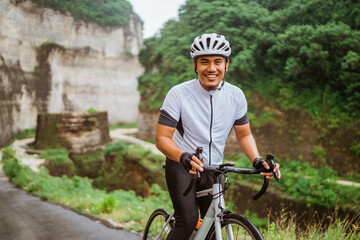 happy smiling road bike cyclist while riding his bike outdoor