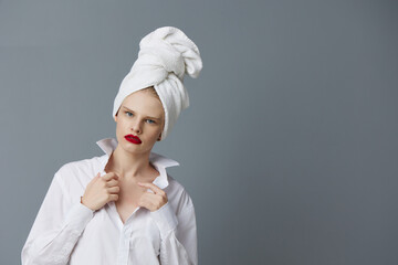 pretty woman with a towel on his head in a white shirt isolated background