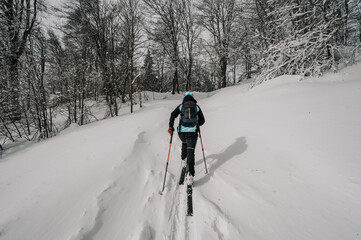 Mountaineer backcountry ski walking ski alpinist in the mountains. Ski touring in alpine landscape...