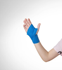 Blue elastic bandage on the arm of the child. White background, close-up