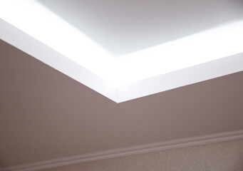 Parts of a designer stretch ceiling with diode lighting. Modern ceiling renovation, interior