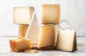 Cheese board of various types of soft and hard cheese. spanish manchego cheese, International dairy delicacies. vertical image
