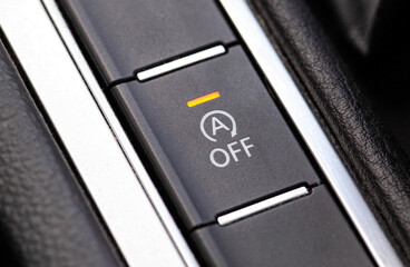 Button to turn off the start-stop system in a modern car, macro