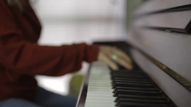 Defocus Image Of A Woman Playing Piano. Selective Focus
