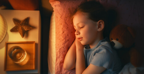 child is sleeping in the bed