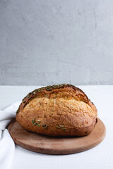 Rye bread on a board on a white tablecloth background