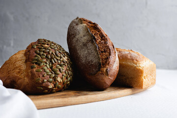 Rye bread on a board on a white tablecloth background