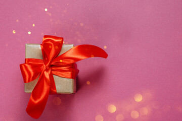 Gifts in kraft paper with red ribbon.