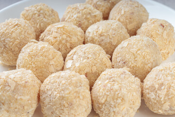 Close-up view of healthy raw paleo energy coconut balls. Soft focus.