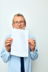 Photo of retired old man holding documents with a sheet of paper light background