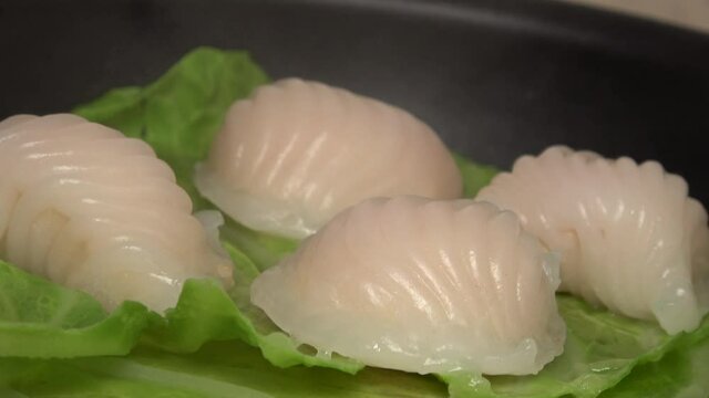 Closeup shot of dim sum shrimp dumplings in the steamer. Har Gow, Chinese crystal prawn dumpling. 4K