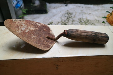 a rusty shovel with a wooden handle