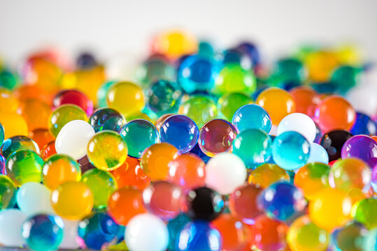 Water beads close-up, abstract background. Texture of Hydrogel balls or many colorful orbeez for wallpaper.