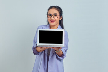 Portrait of cheerful young Asian business woman showing blank laptop screen to present products isolated on white background