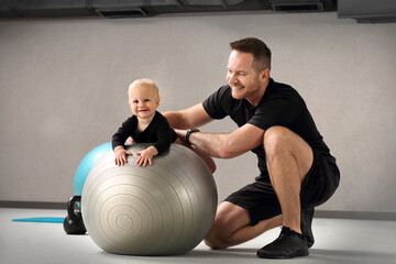 Physiotherapy and rehabilitation of a child. Physiotherapist exercises with a baby on a ball.