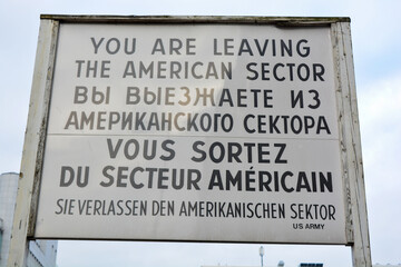 You are leaving the American Sector, historical sign in English, Russian and French script at Checkpoint Charlie in Berlin, Germany