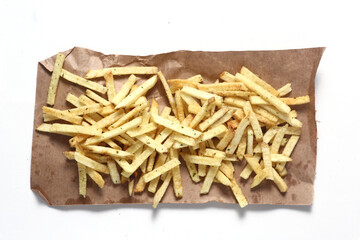 fast food concept - french fries on kraft paper isolated on white background flat lay