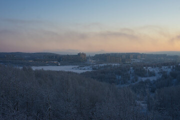 frosty nature landscape with trees, sky and sun
