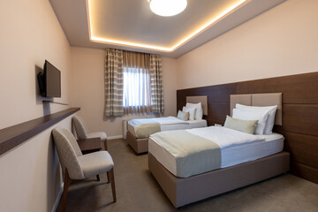 Interior of a luxury hotel double bed bedroom in the morning