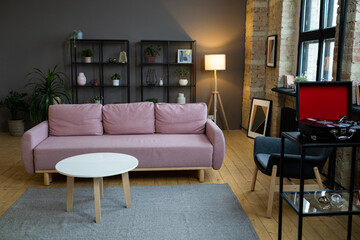 Image of modern sofa with coffee table in front of it in the living room in the apartment