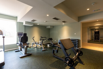 Fototapeta na wymiar Interior of an empty hotel gym with equipment