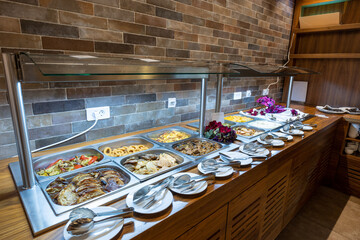 Breakfast served on a buffet table in a hotel restaurant