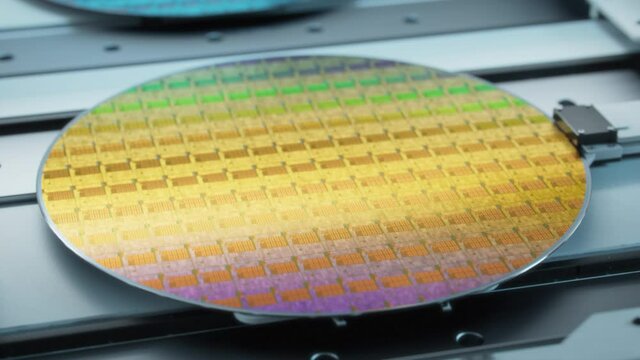 Beauty Shot of Colorful Silicon Wafer at Advanced Semiconductor Foundry, that produces Computer Chips.