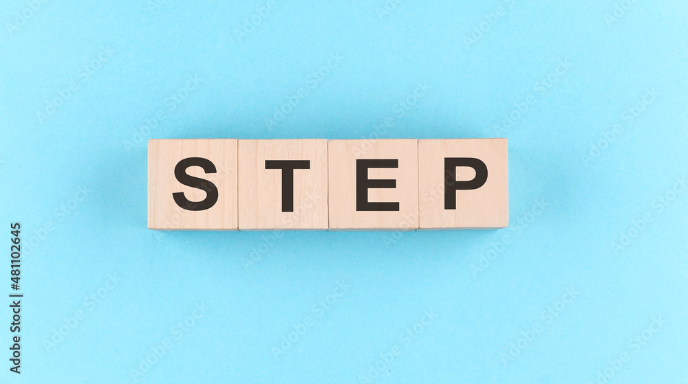 Poster wooden cube block with text step on the blue background