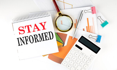 White notepad text STAY INFORMED with diagram,chart,calculator on the white background