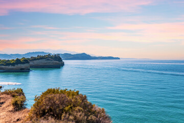 Boats sailing on sea near Corfu island under blue sky