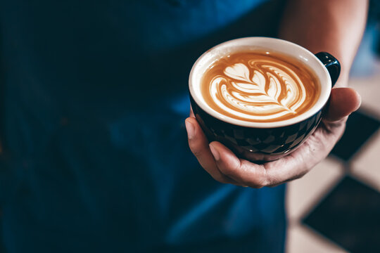 Cup of coffee latte art with coffee shop.
