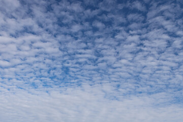Beautiful blue sky view of lovely small clouds.