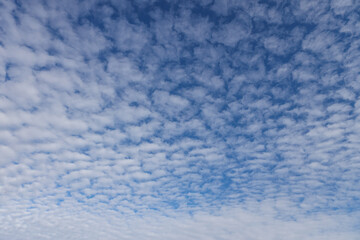 Beautiful blue sky view of lovely small clouds.