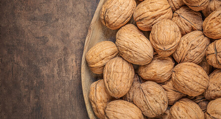 Walnuts on dark vintage table. Walnuts kernels  top view, copyspace.