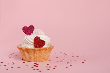 Valentine's day pink background. Vanilla cupcake decorated red heart candle