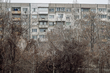 A gray residential building from the socialist era, made of prefabricated concrete panels in Sofia...