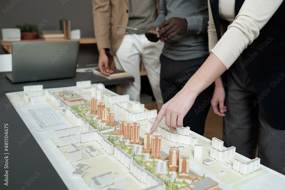 Aufkleber hand of female architect pointing at layout during presentation of architectural project to male cow