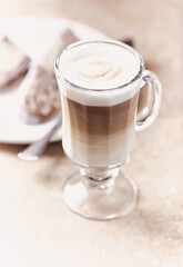 Coffee with milk on bright stone background. Soft focus. Close up.	