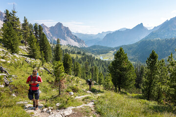 Fototapeta na wymiar Hiker above a beautiful valley in the Dolomite Mountains