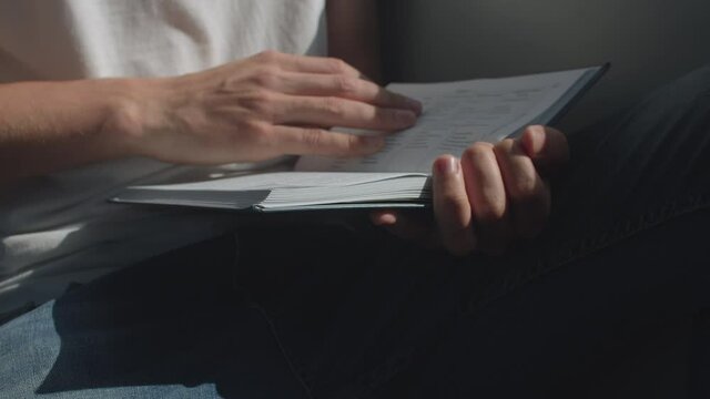 The passenger is leafing through the Bible book in public transport. Conversion to religion anytime and anywhere.