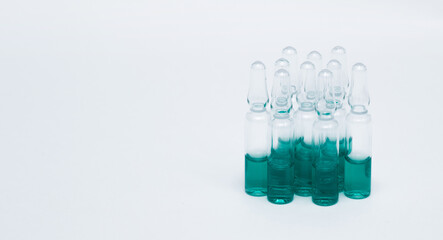 Medicinal or cosmetic ampoules jars of vaccines isolated on white background as a concept of cosmetology medicine and treatment with syringes injections.