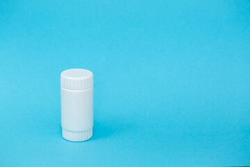 White different medical or cosmetic jars on a blue background as a concept of cosmetology of medecine and treatment
