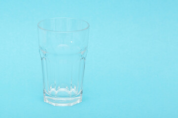 A glass with pure cool water on a blue background