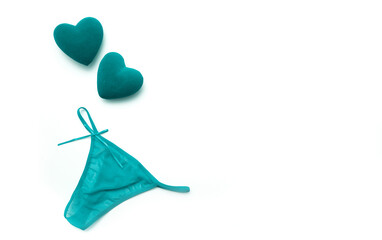 Panties and bra under the lace of a turquoise color set of female lower intimate romantic underwear on a white background