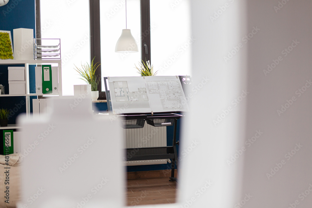 Poster stand with drawing plans for real estate development in modern architect open space office. architec