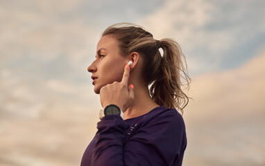 Sportswoman listening to music during training