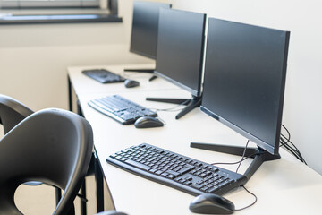 Laptop and landline phone on desk at office