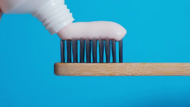 Toothbrushes eco friendly made of natural bamboo. Toothpaste close up. House with zero waste. Blue background