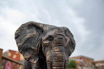 Fototapeta na wymiar Iron figurine of an elephant against the sky.